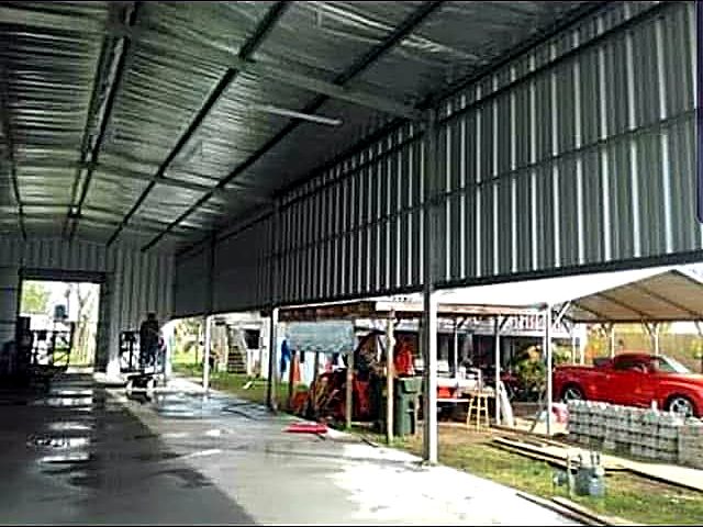 Interior of a steel building bay with metal wall sheeting and open drive-through ends