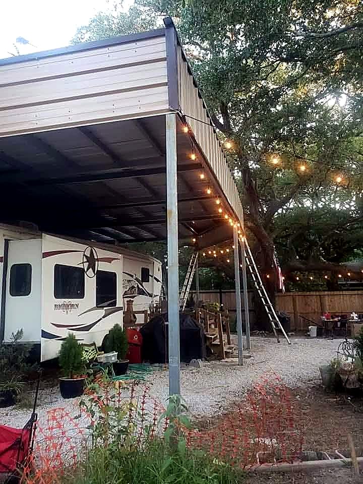 Galvanised steel posts and beams supporting a tall RV cover beside a fifth wheel