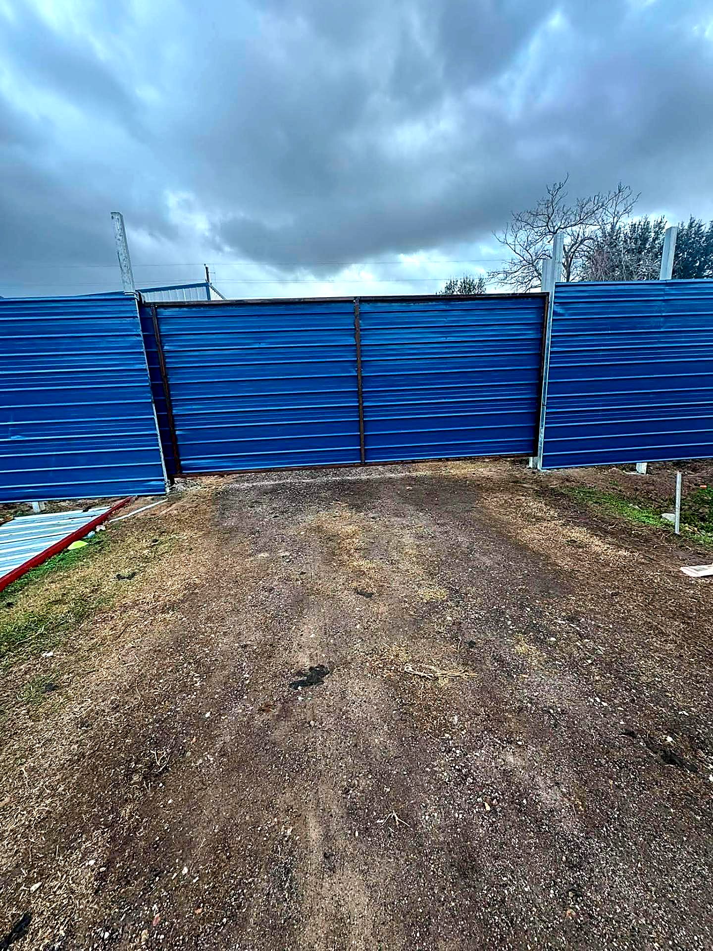 Blue metal panel fence and double gate on a steel frame