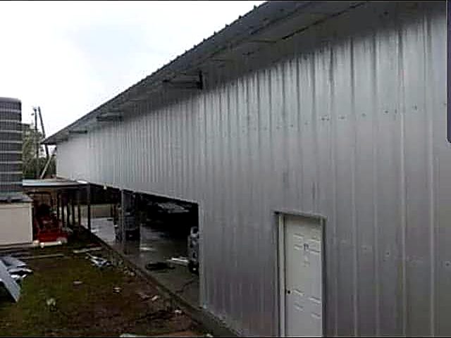 Long run of grey metal siding on a commercial steel building