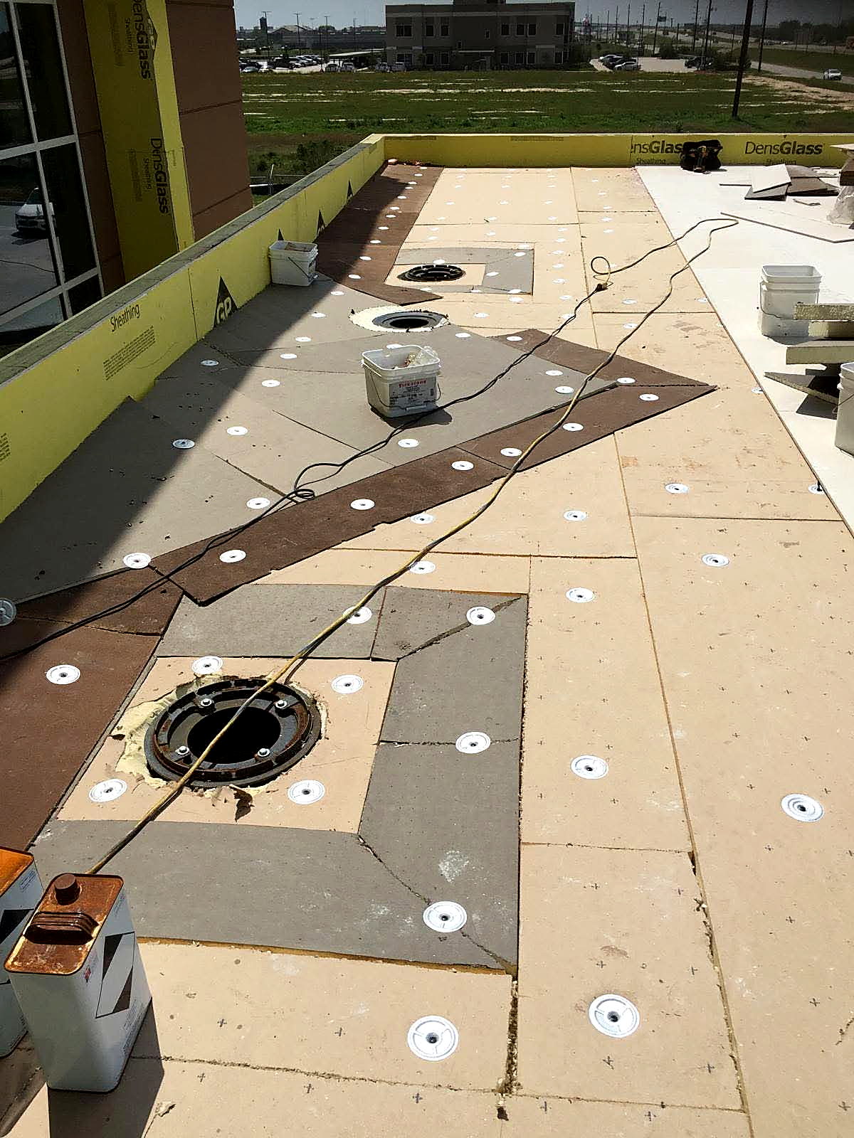 Roof drains set into tapered insulation before membrane installation