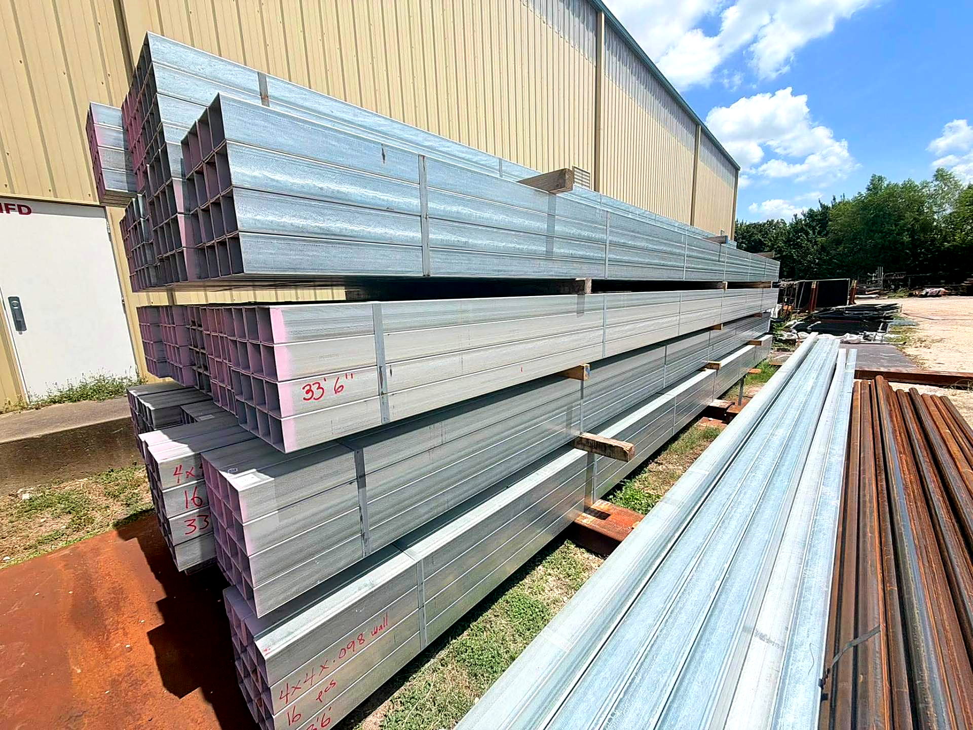 Bundles of galvanized steel tubing in the yard