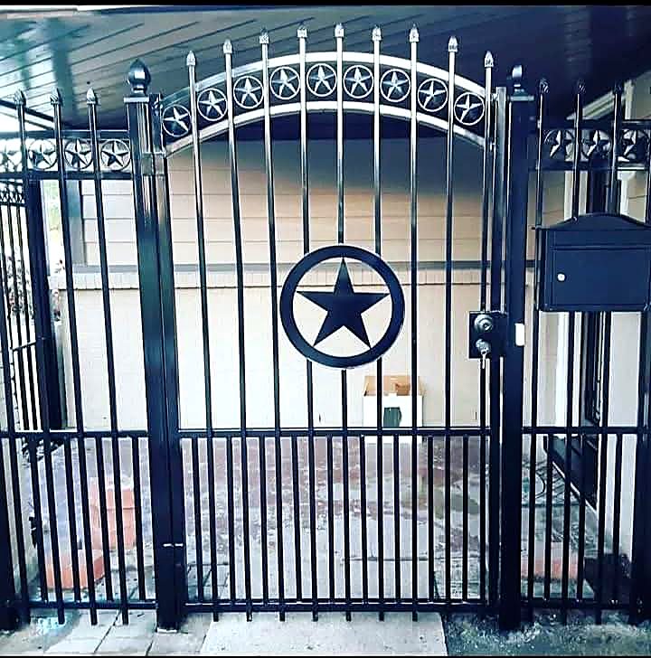 Black iron gate with Texas star centre and star detail along the arch